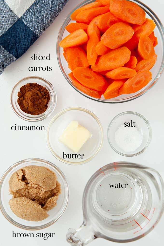 All of the ingredients needed to make brown sugar carrots such as sliced carrots, cinnamon, butter, and brown sugar