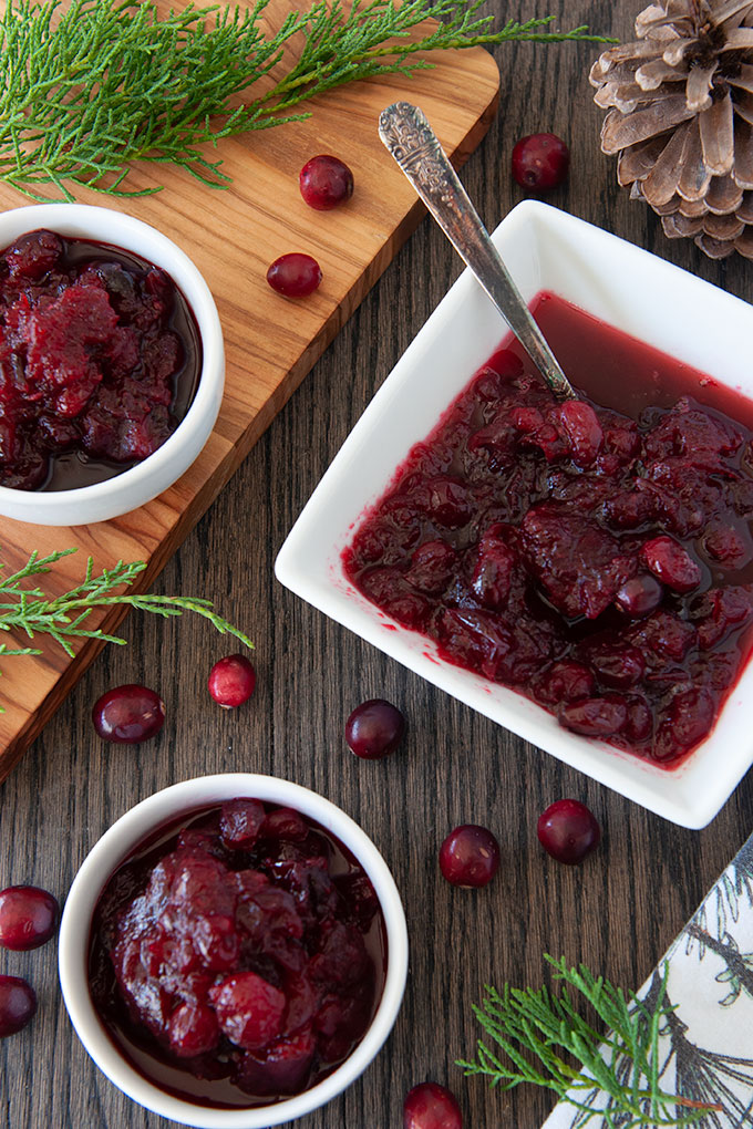 Above view of square serving dish and two small bowls of cranberry sauce.