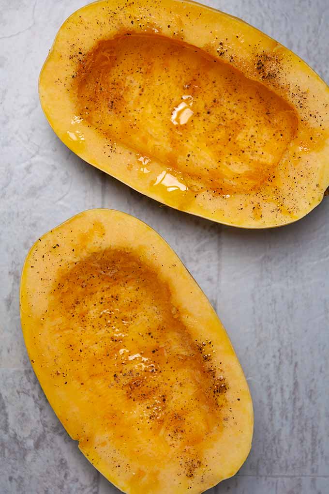 Cut in half spaghetti squash drizzled with olive oil, salt, and pepper