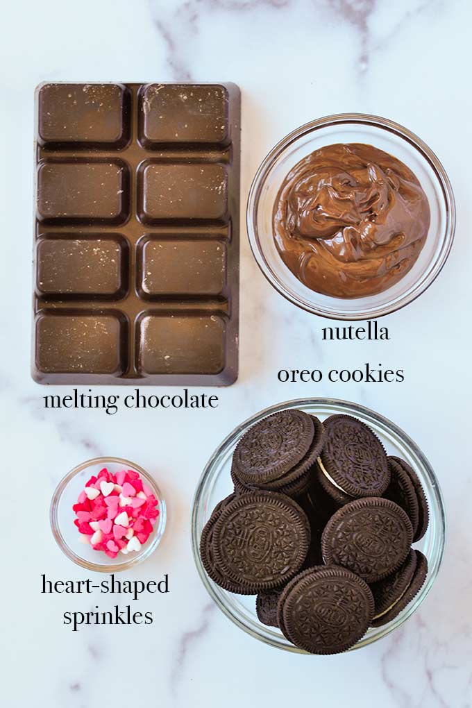 All of the ingredients needed to make Nutella truffles such as Oreos, Nutella, and melting chocolate.