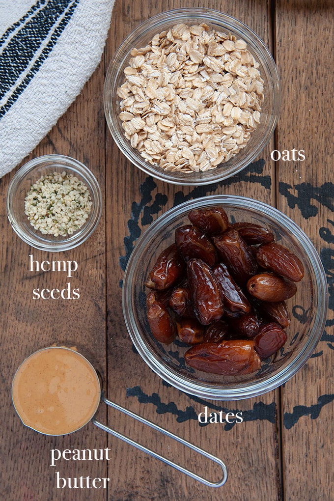 All of the ingredients to make energy balls which are oats, dates, peanut butter and hemp seeds.