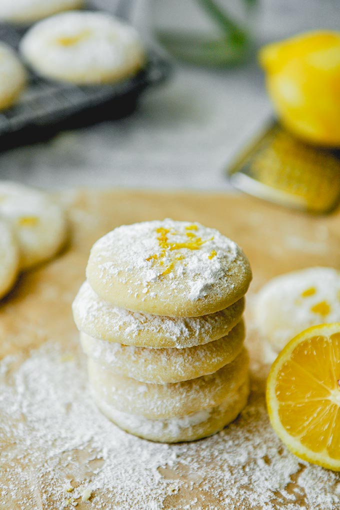 A stack of Lemon cooler cookies with a lemon next to it.