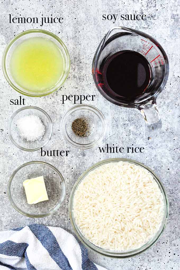 All of the ingredients needed to make lemon butter rice like white rice, soy sauce, butter, and lemon.