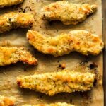 Above view of a baking sheet with baked almond flour chicken tenders.