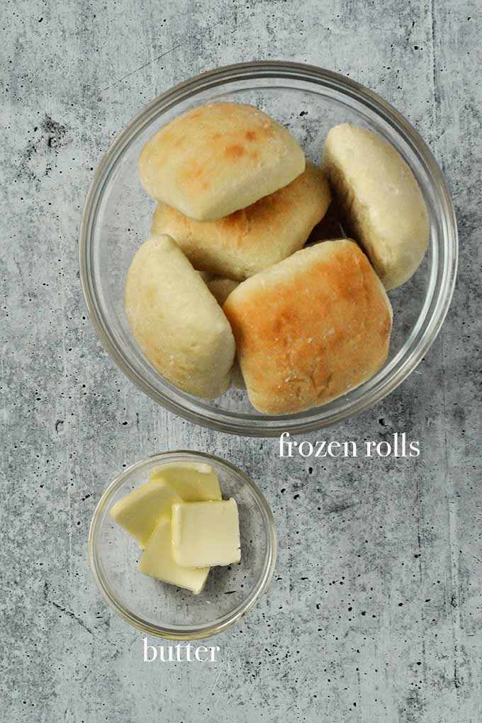 The ingredients for Frozen rolls in air fryer are frozen dinner rolls and butter.