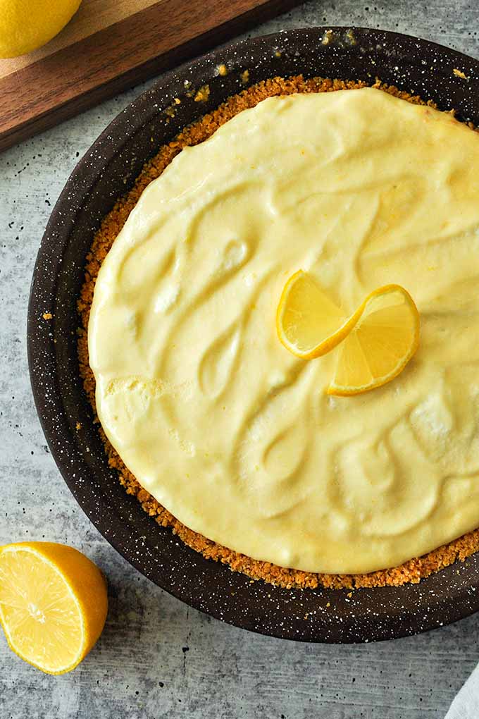 A closeup of lemon freeze pie with lemon on top.