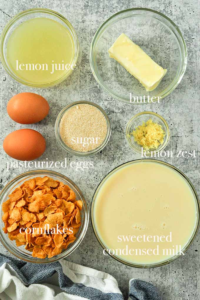 All of the ingredients needed to make freezer pie recipe including cornflakes, sweetened condensed milk, lemon zest, and butter.