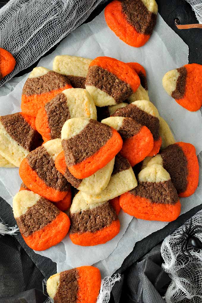 An above view of a tray of candy corn cookies.