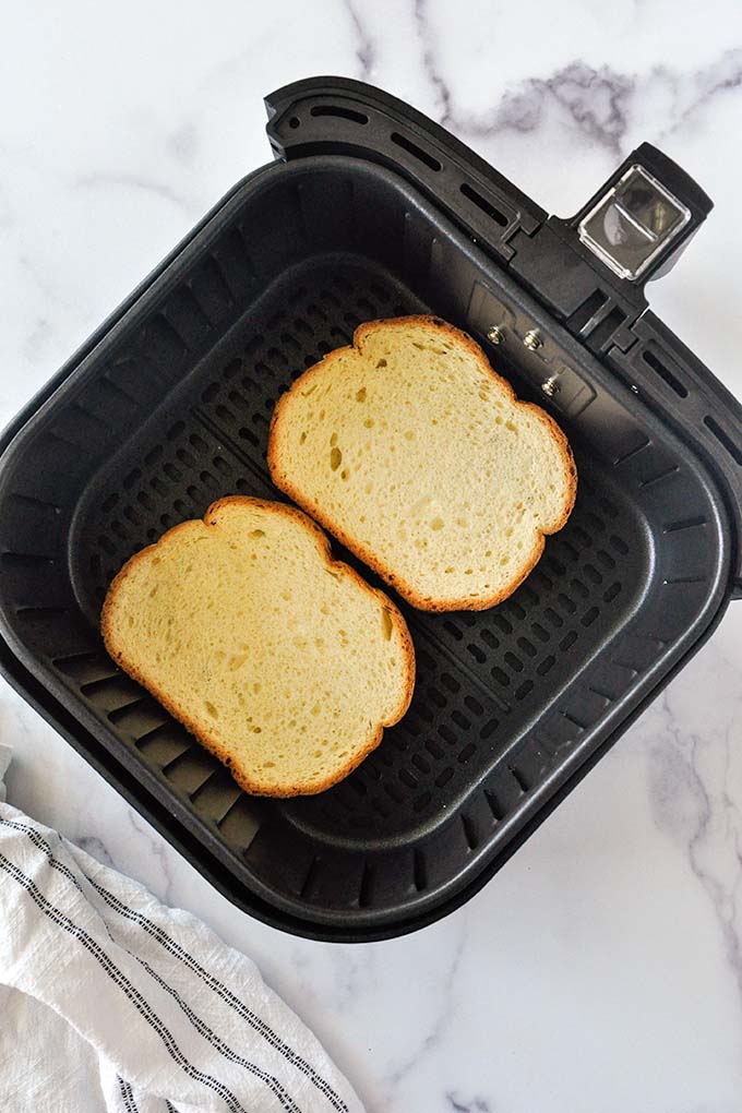 Bread that's been set into an air fryer basket.