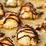 Coconut macaroons with condensed milk and a drizzle of chocolate on top.