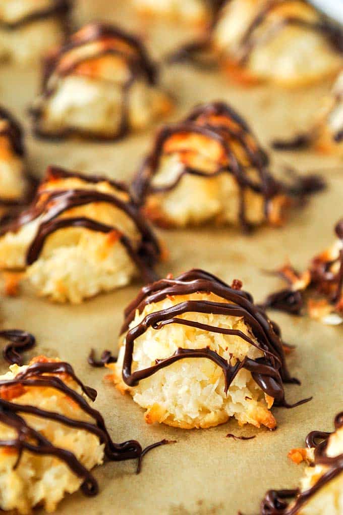 Coconut macaroons with condensed milk and a drizzle of chocolate on top.