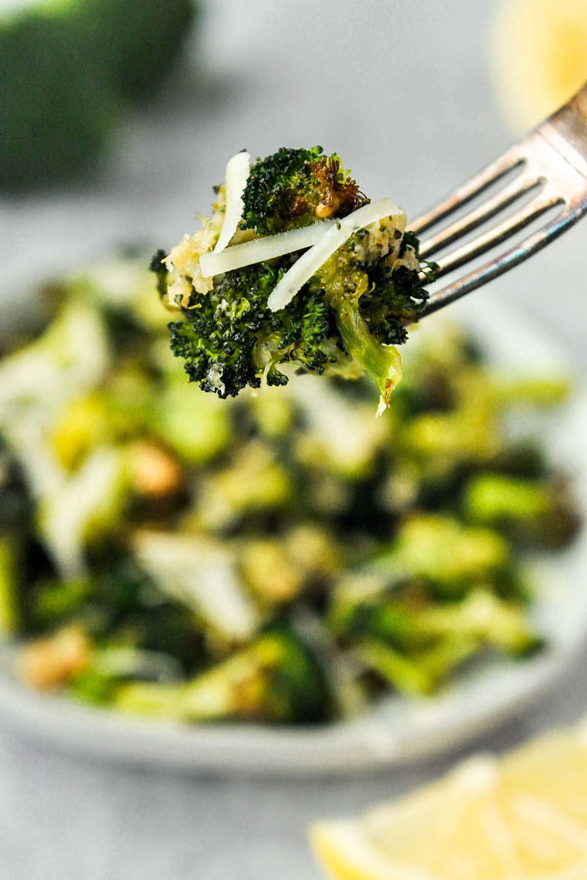 A fork full of air fried broccoli Parmesan.