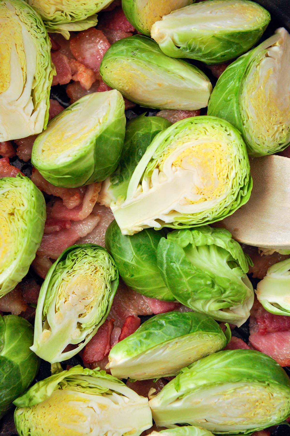 Up close of cut brussel sprouts and bacon.