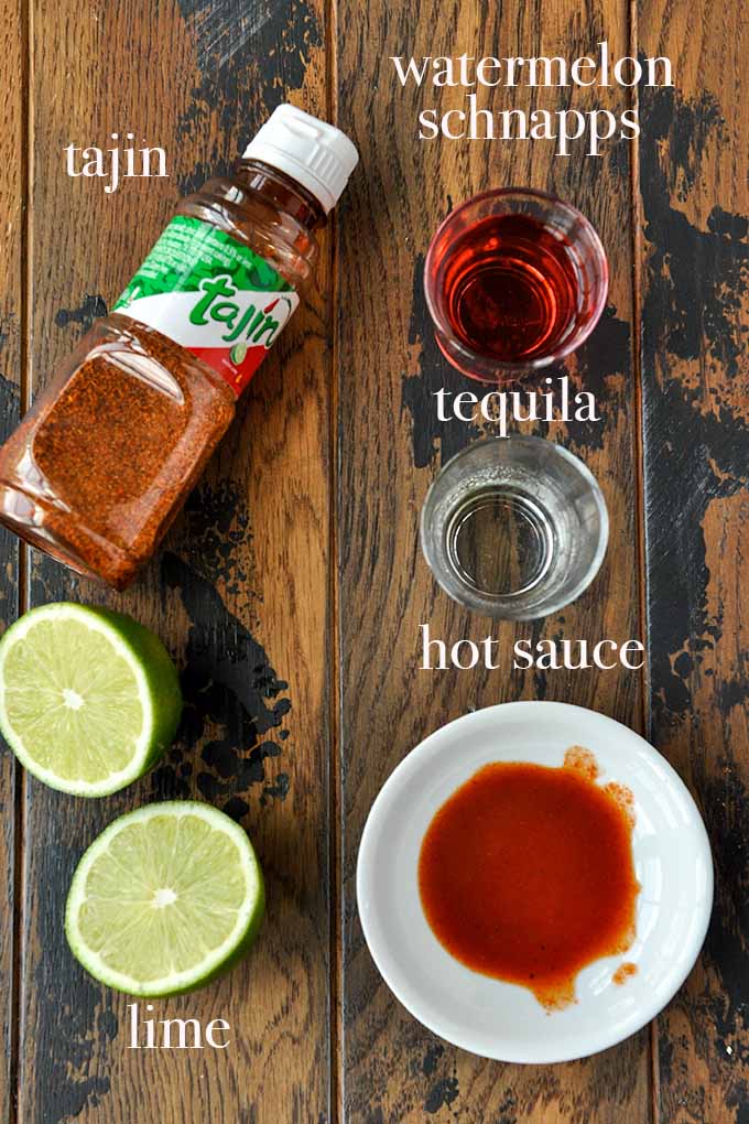 All of the ingredients needed to make Mexican candy shot like lime juice, watermelon schnapps, and hot sauce.
