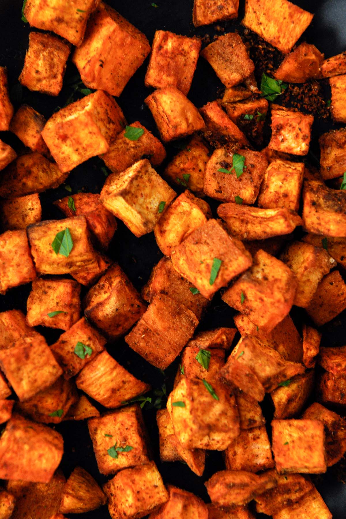 Very up close image of cubed sweet potatoes.