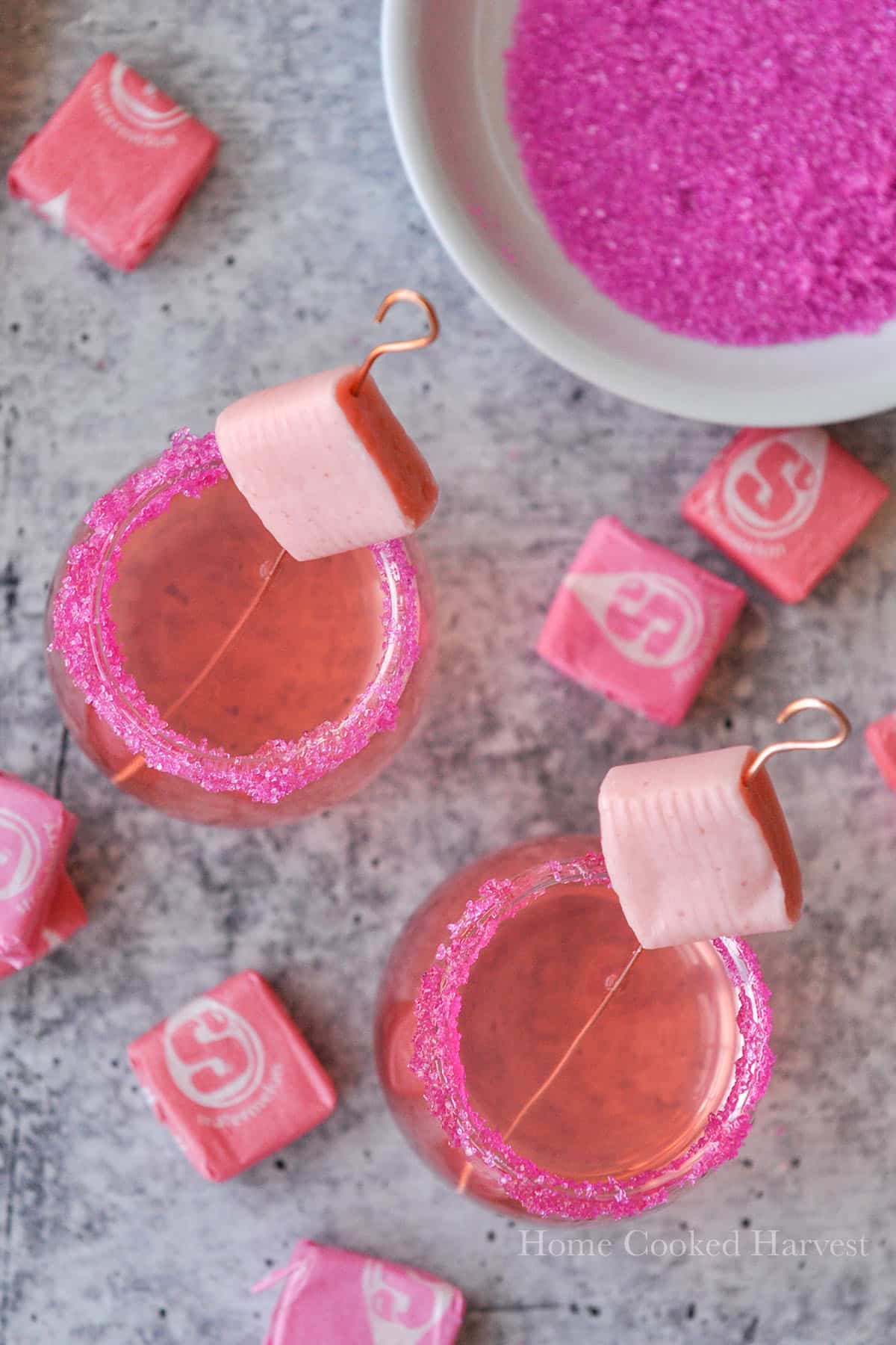 Above view of starburst shots with a small plate of pink sugar and starbursts.
