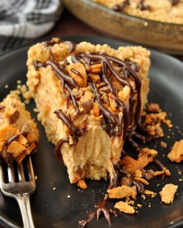 An up close slice of butterfinger pie with a bite taken with a fork.
