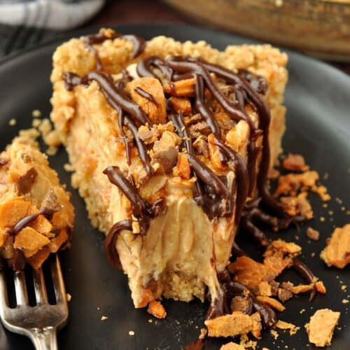 An up close slice of butterfinger pie with a bite taken with a fork.