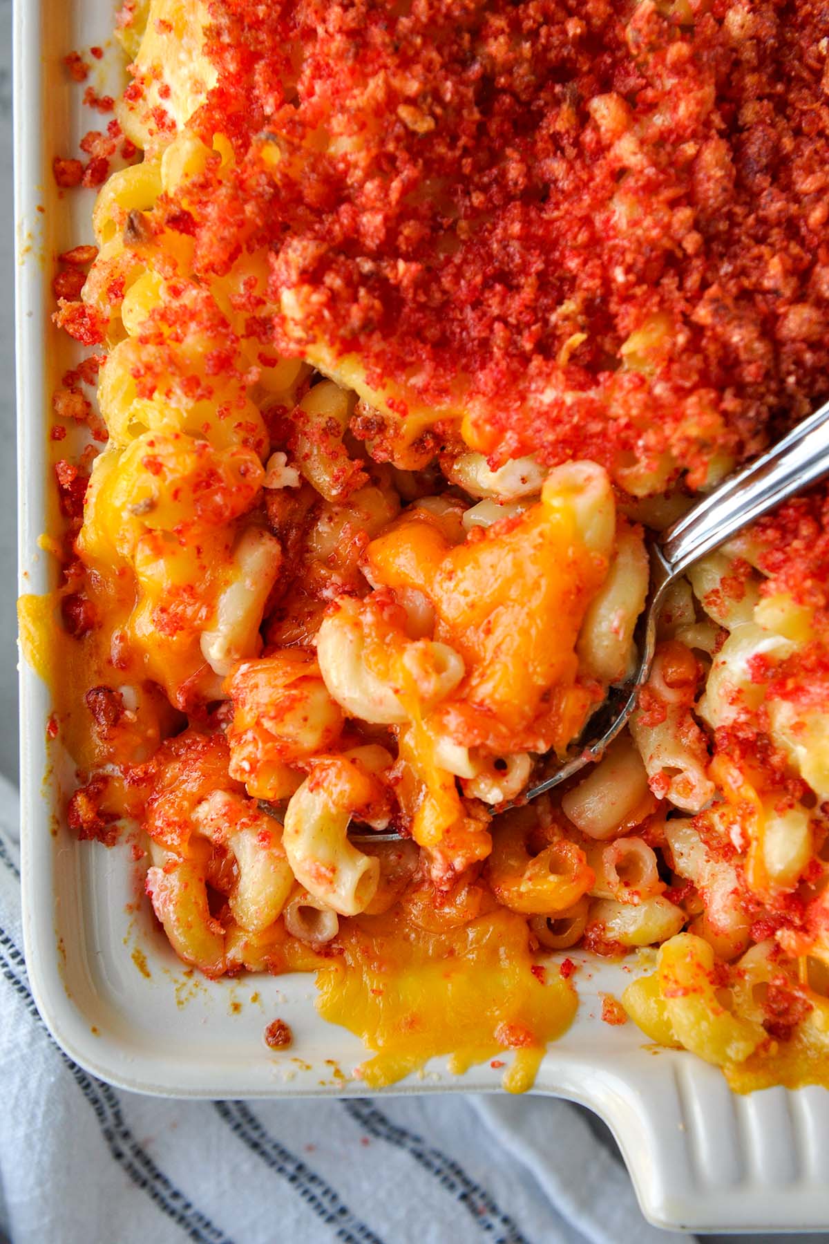 Above view of Mac and cheese in a baking dish with a spoon.