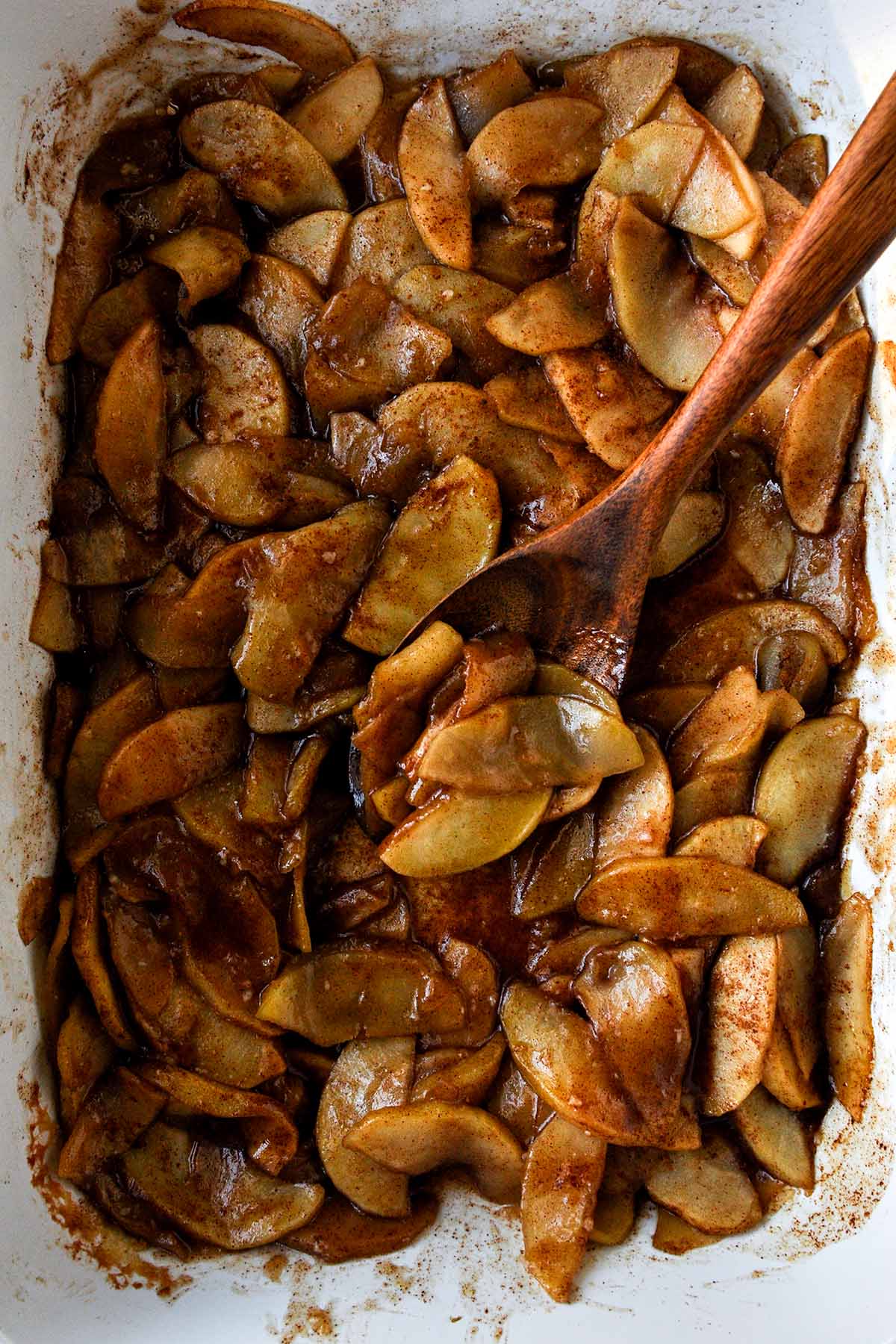 Baking pan filled with cooked cinnamon apples.