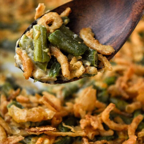 A big spoon full of delicious green bean casserole.