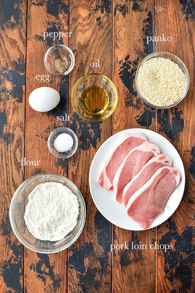 All of the ingredients needed to make this recipe including pork loin chops, flour, panko, salt, pepper, oil, and an egg.