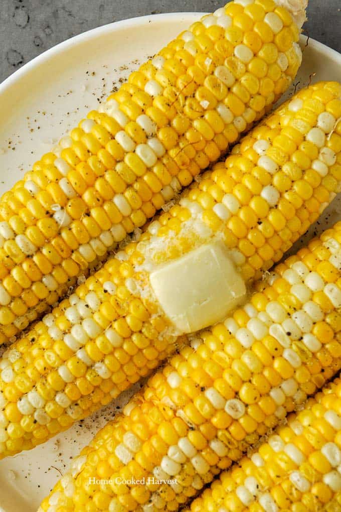 Up close of melting butter on cooked corn.