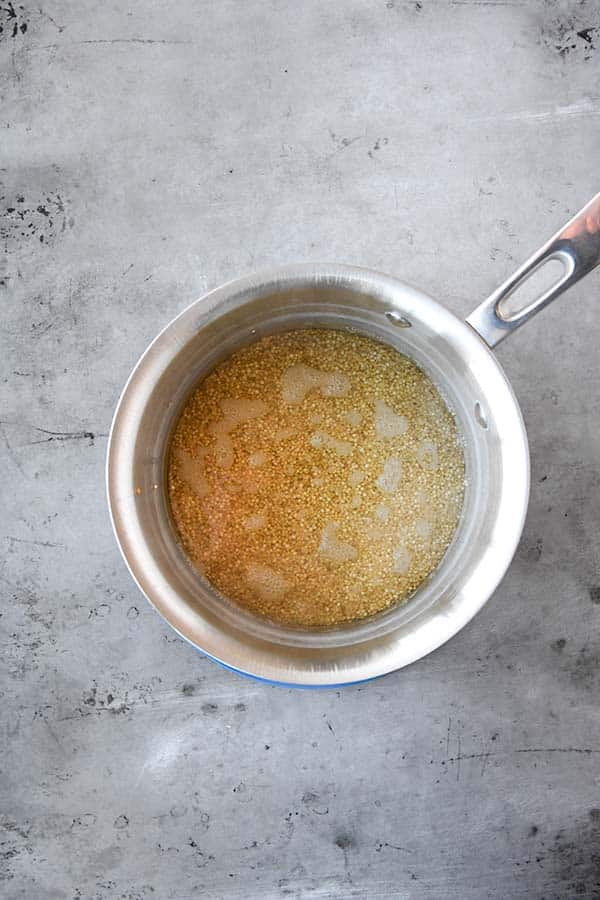 A pot of cooking quinoa.