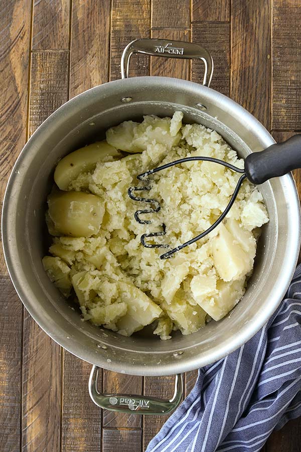Step three is to smash up the cooked potatoes.