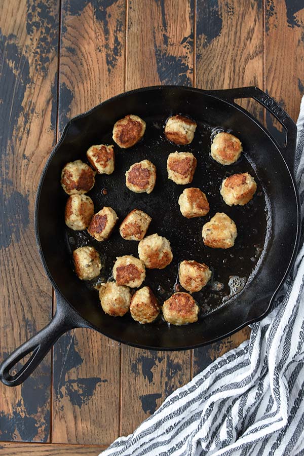 Step three is turning the meatballs to sear all sides.