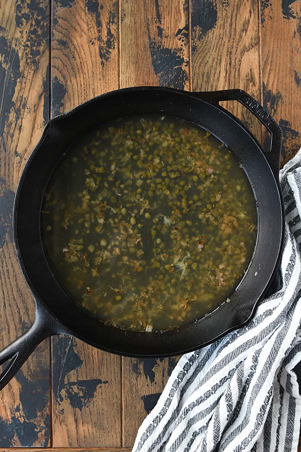 Step five is adding in the lemon juice and broth to the pan.