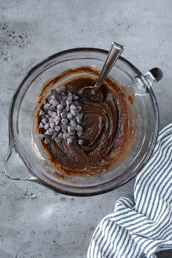 Step three is the mixed brownie batter with the chocolate chips added and a spoon.