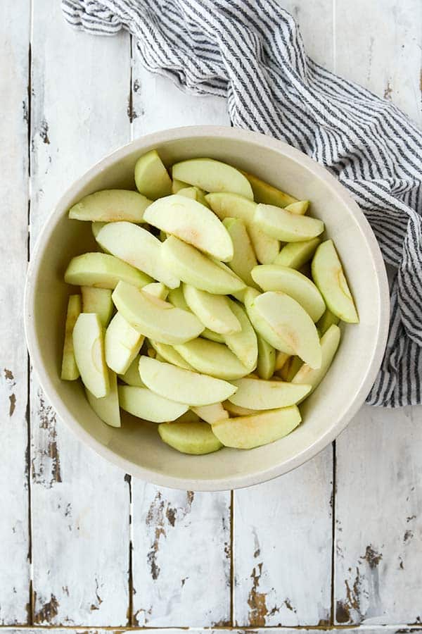 Step one is a bowl full of cut apples.