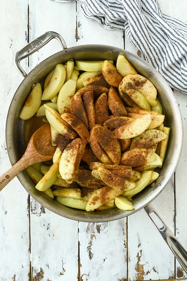 Step three is adding all of the spices to the cut apples.