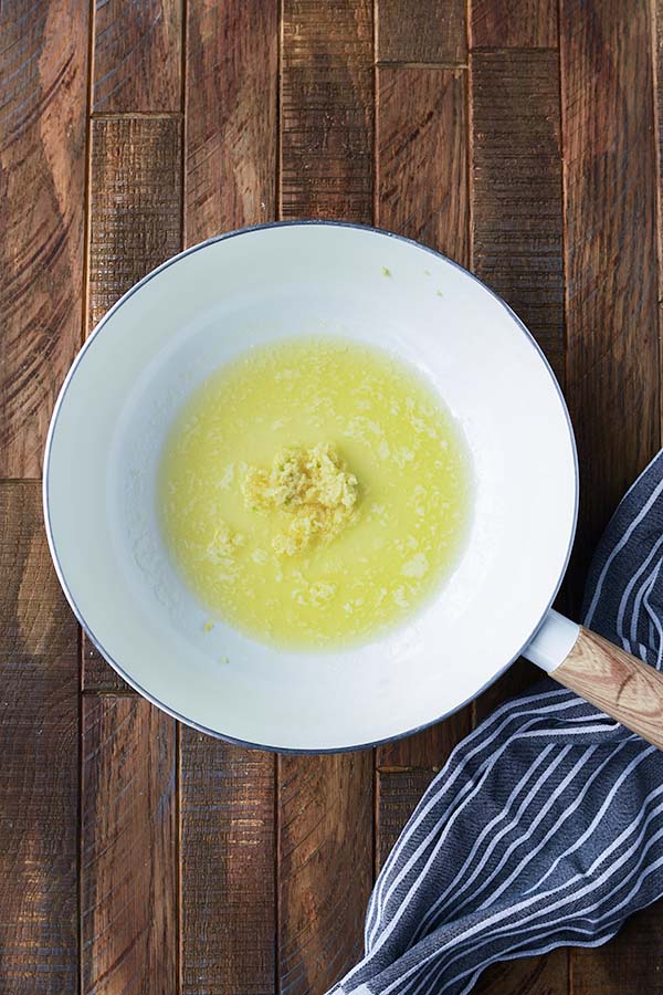 Step two is a pan of melted butter and minced garlic.