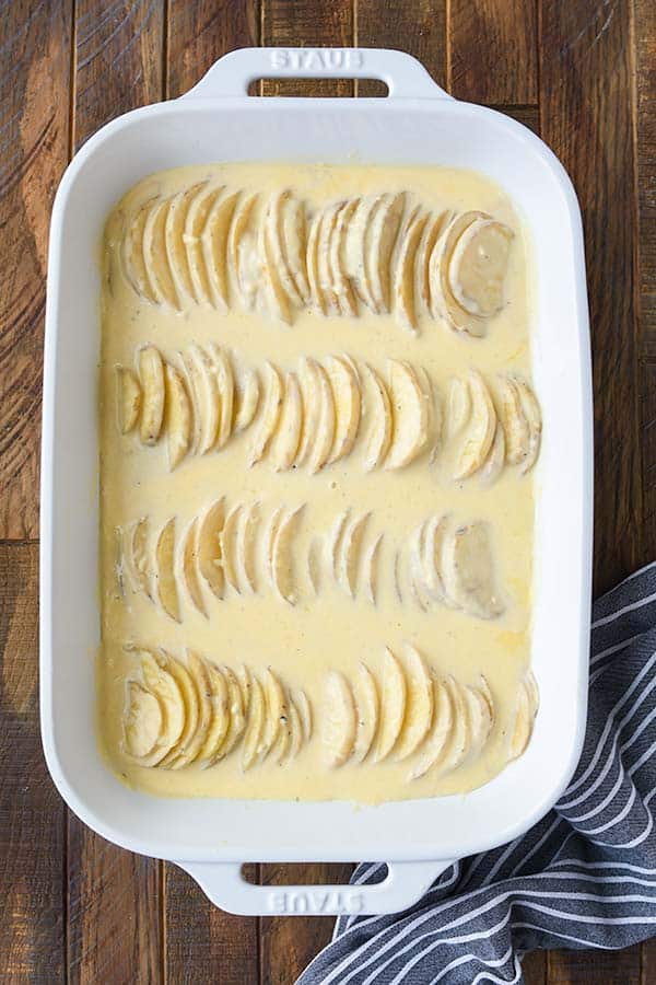 Step six is the sauce poured over the potatoes. Then they get put in the oven.