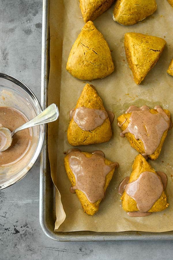 Step 10 is the cooked scones getting a small spoonful of mixed icing.