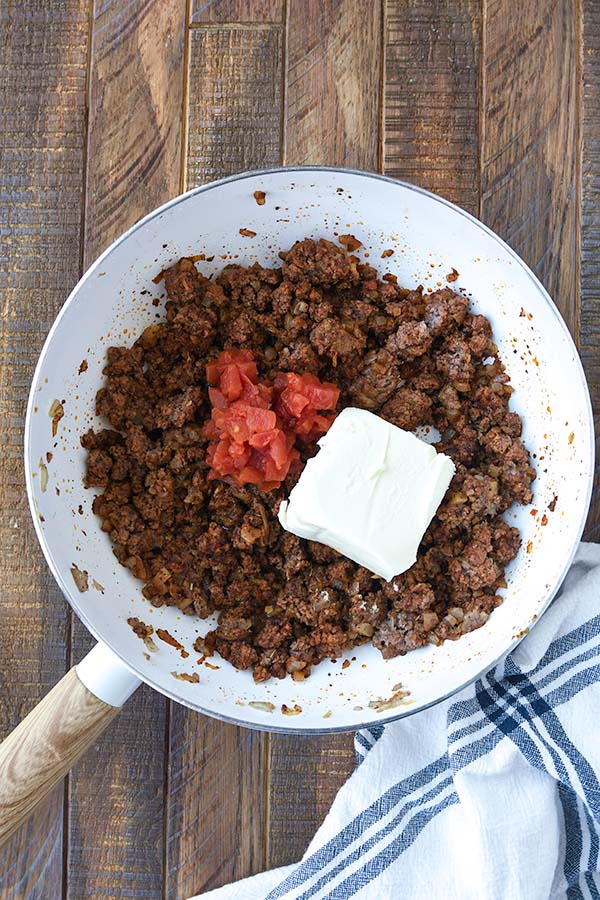 Step four is the canned tomatoes and cream cheese added to the beef mixture.