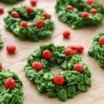 A baking tray with cornflake wreaths on top of brown parchment paper.