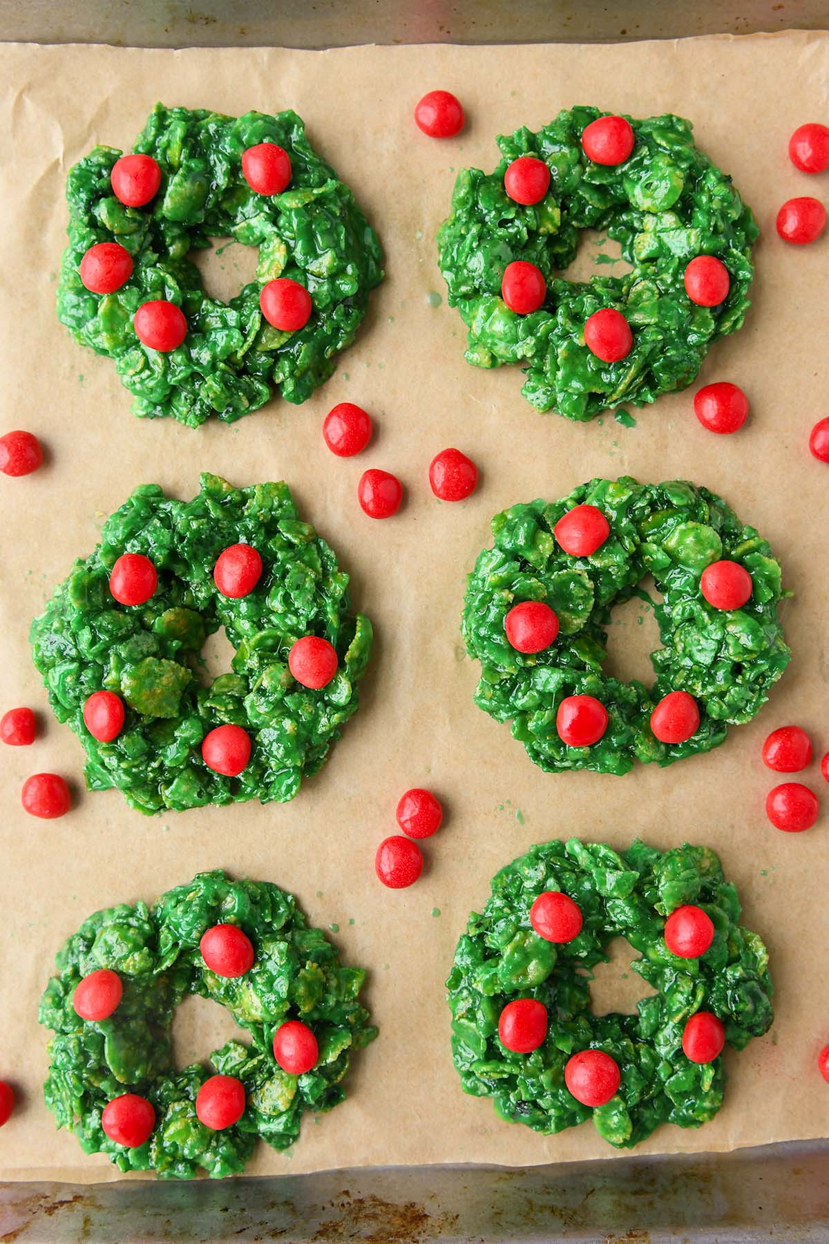 An above view of six of the wreaths on a baking sheet.
