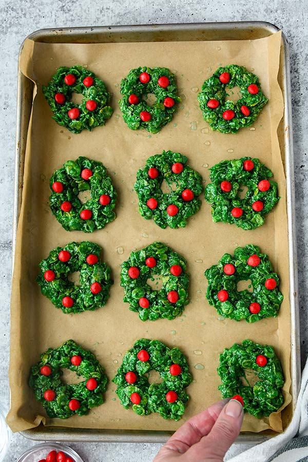 Step four is forming the wreaths and adding the red cinnamon candies.