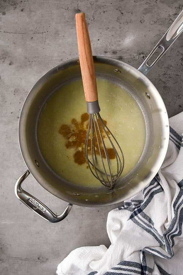 Step two is slowly whisking in broth.