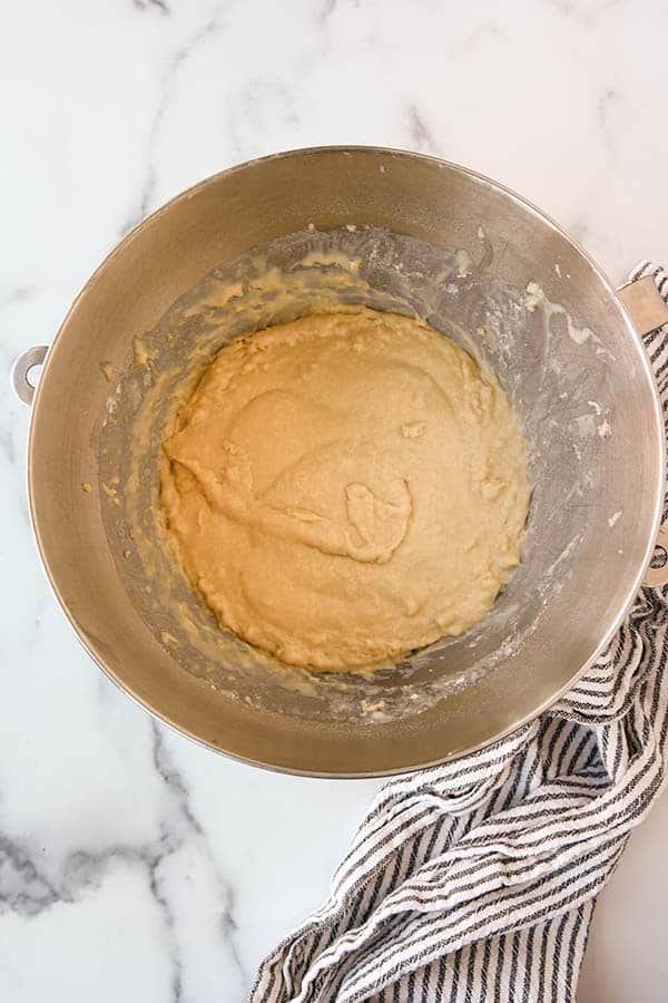 Step three is to mix the dough and add a little flour at a time until it stops sticking to the sides.