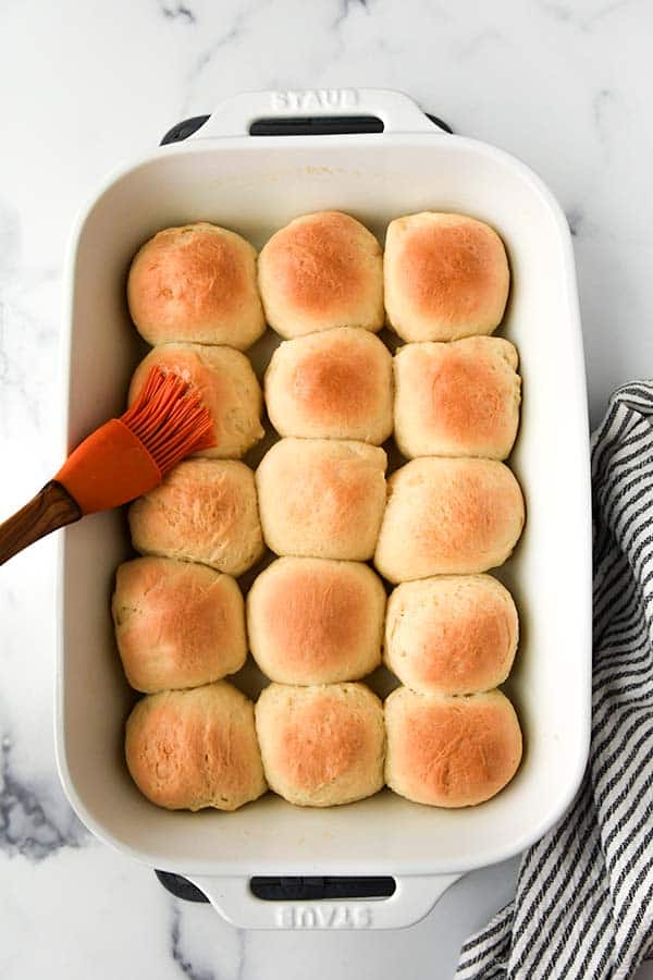 Step nine is to butter the cooked rolls.