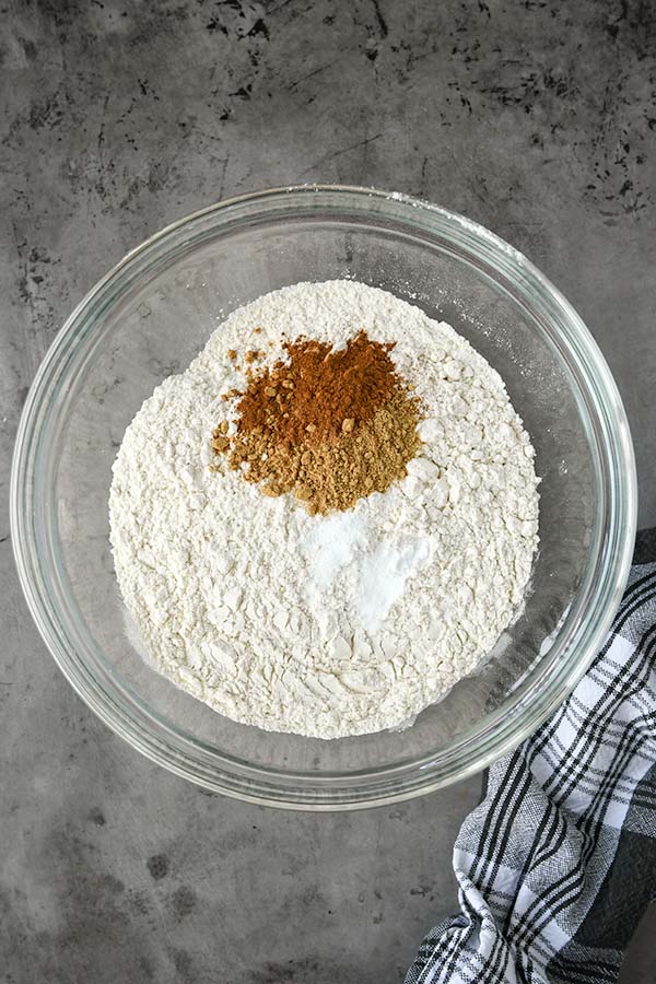 Step one is a glass bowl with the flour, cinnamon, ground ginger, baking soda, and salt.