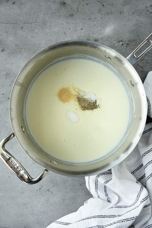 Step three is the seasonings being added to the roux in a pan.