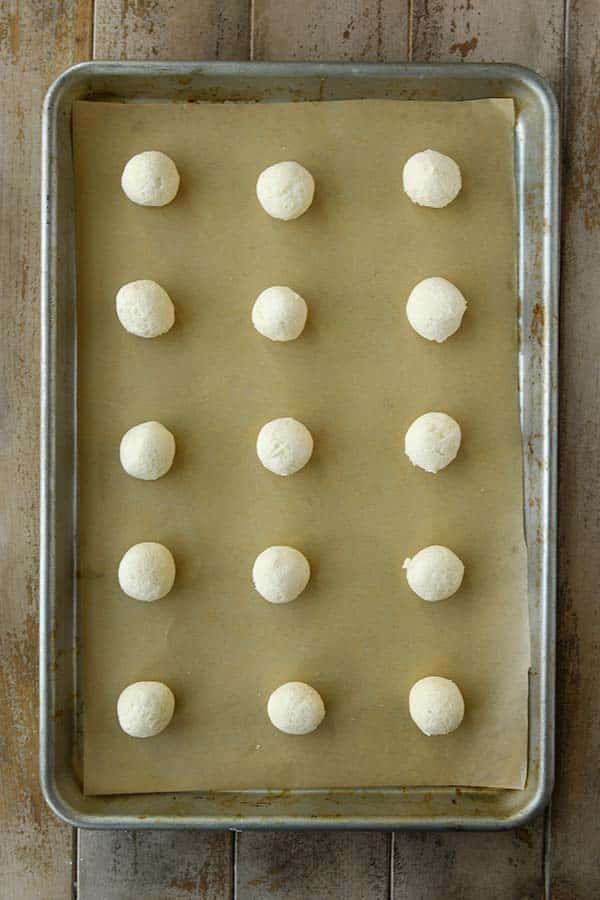 Step four is a baking tray with rolled balls of cookie dough.