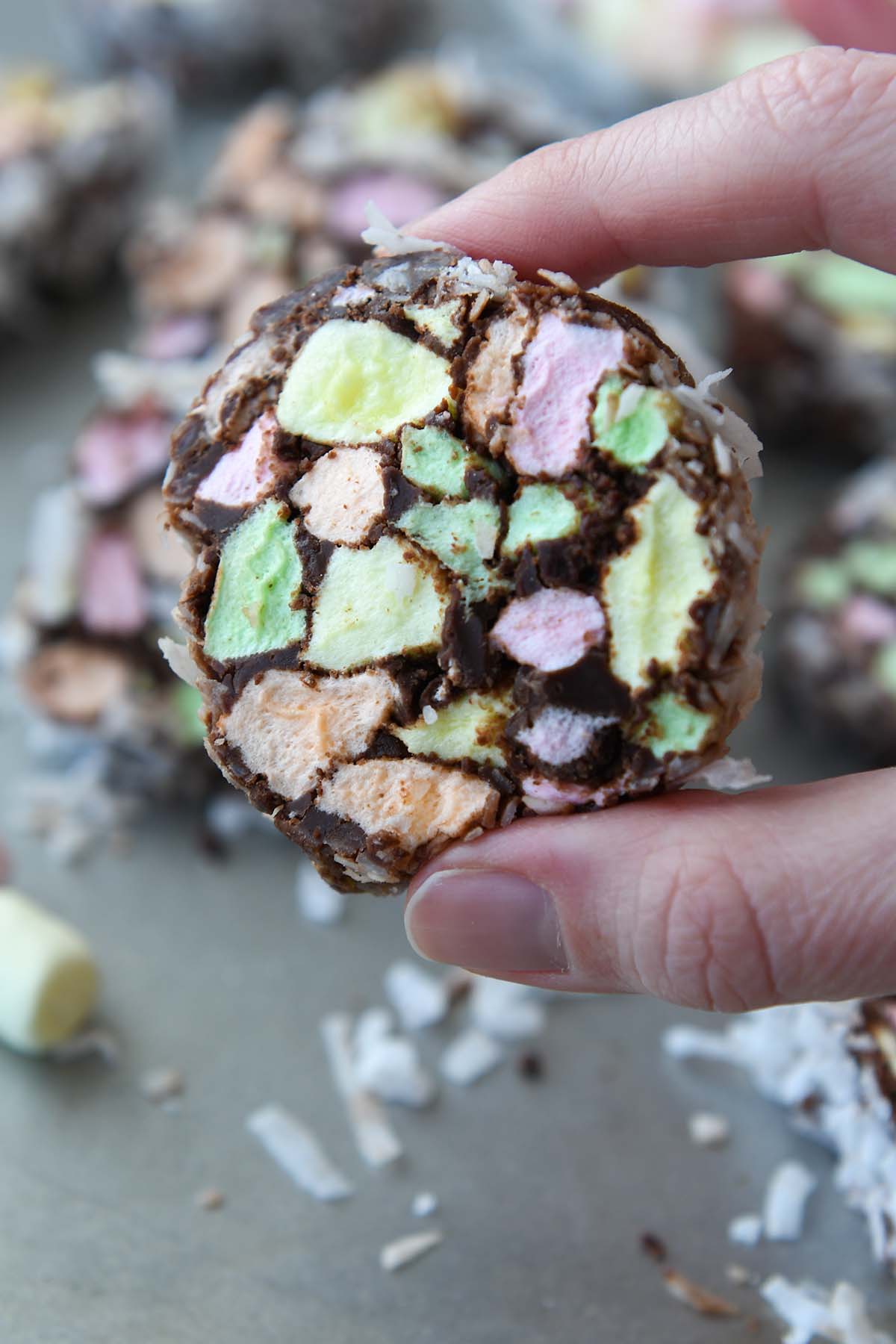 One cut cookie being held up.