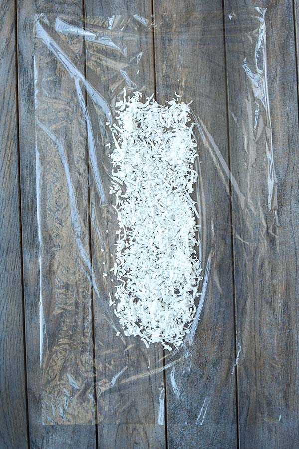 Step two is plastic wrap with shredded coconut.