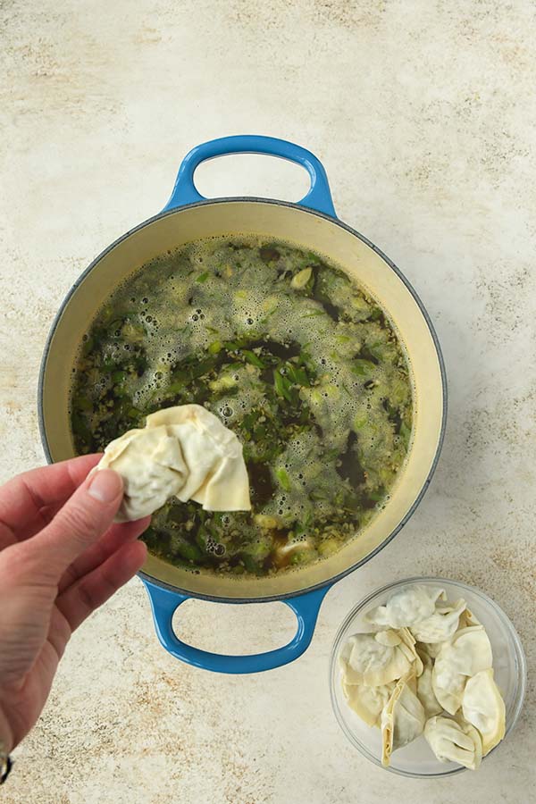 Step 3 is adding the frozen dumplings to the hot broth.